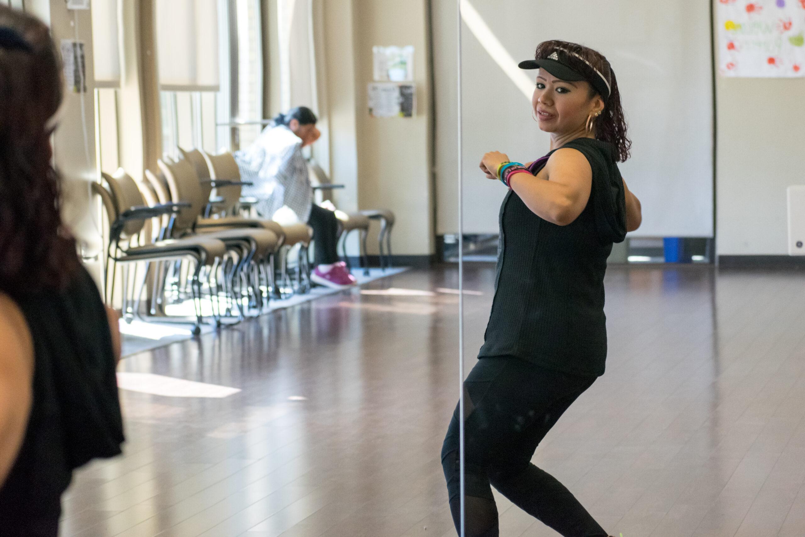 a zumba instructor teaching a zumba class