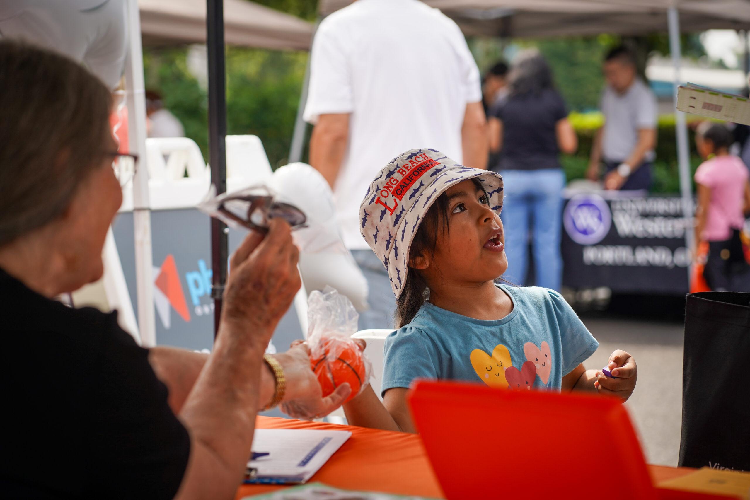 A child participating in a community health fair activity