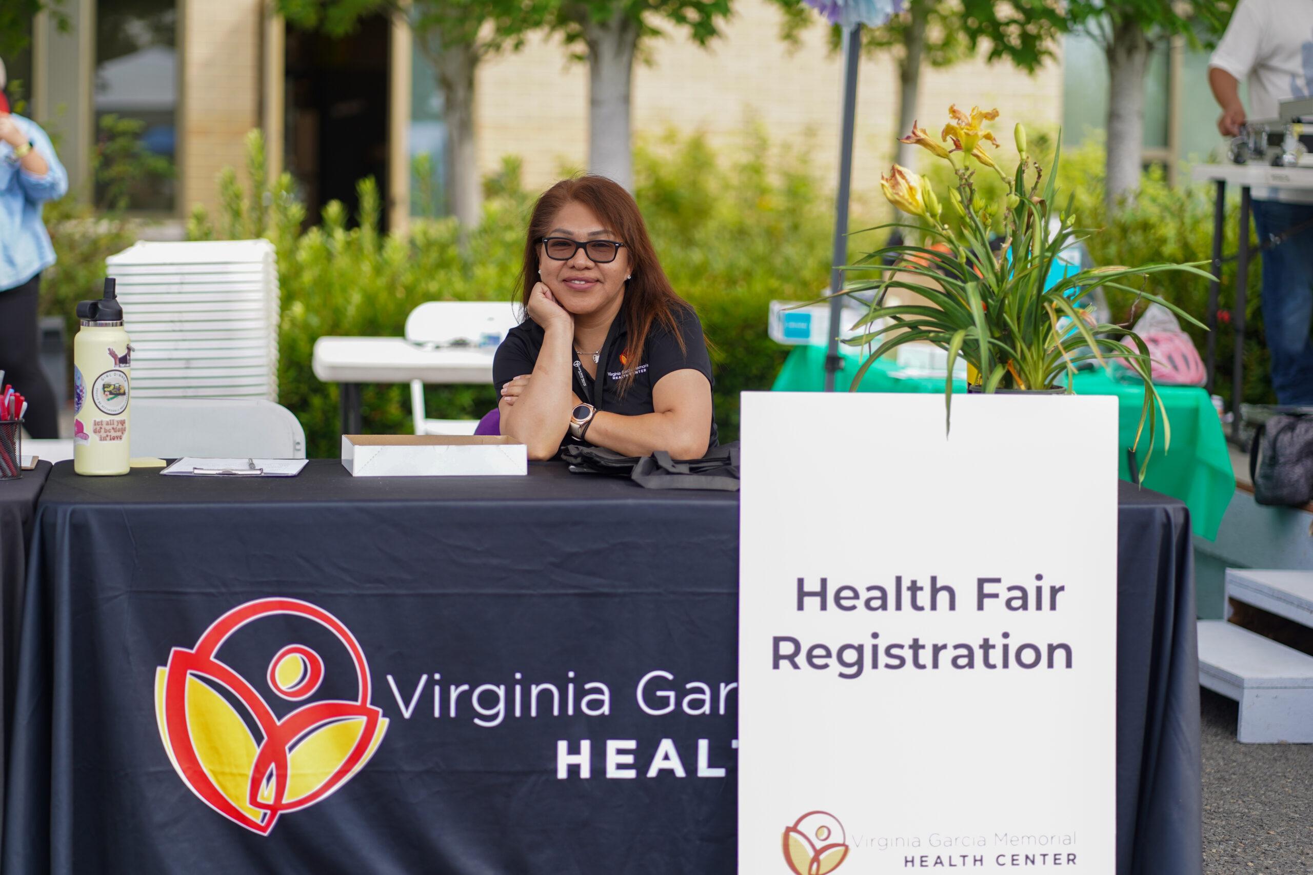 Woman sitting at the health fair registration booth