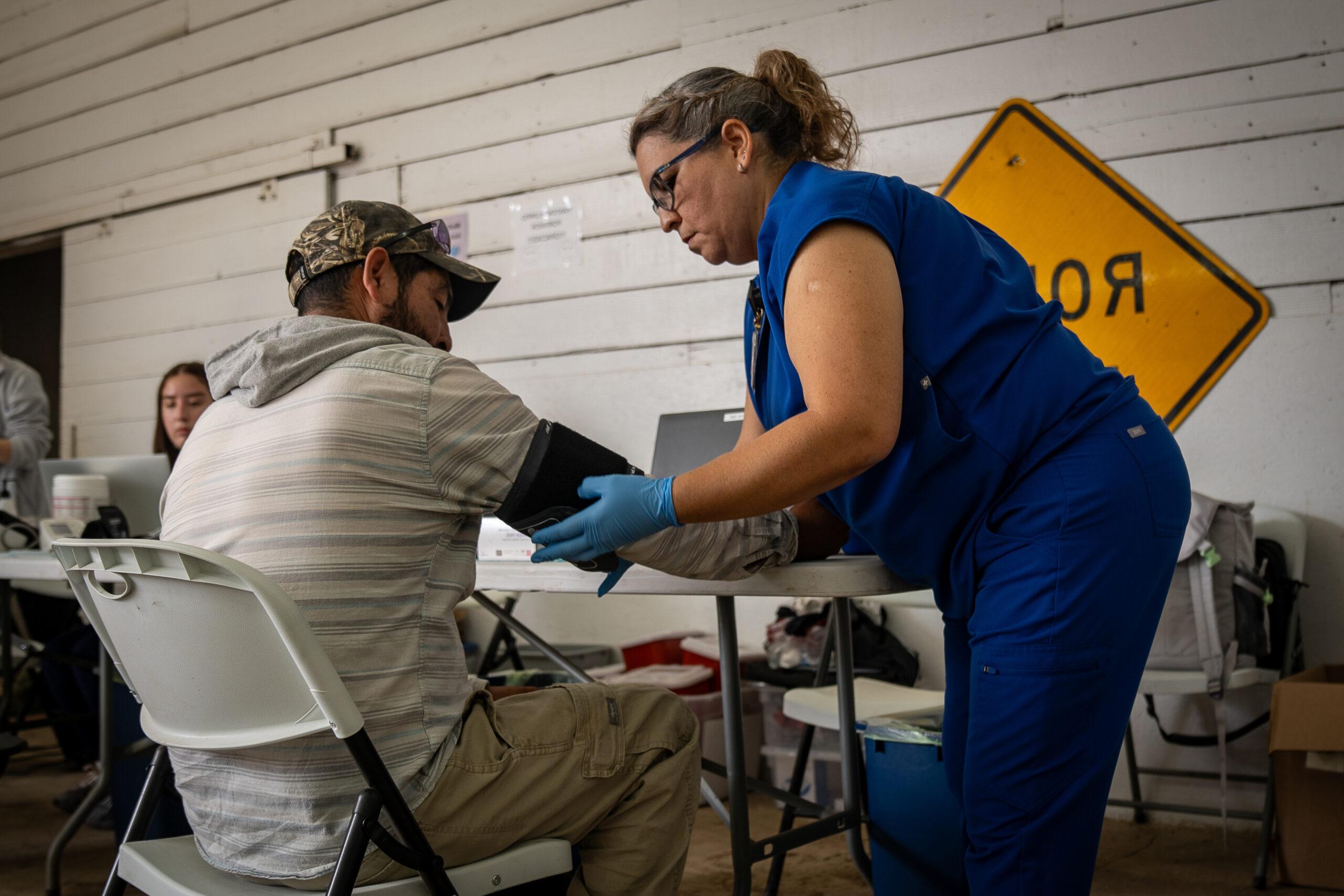 Medical professional taking blood pressure of patient