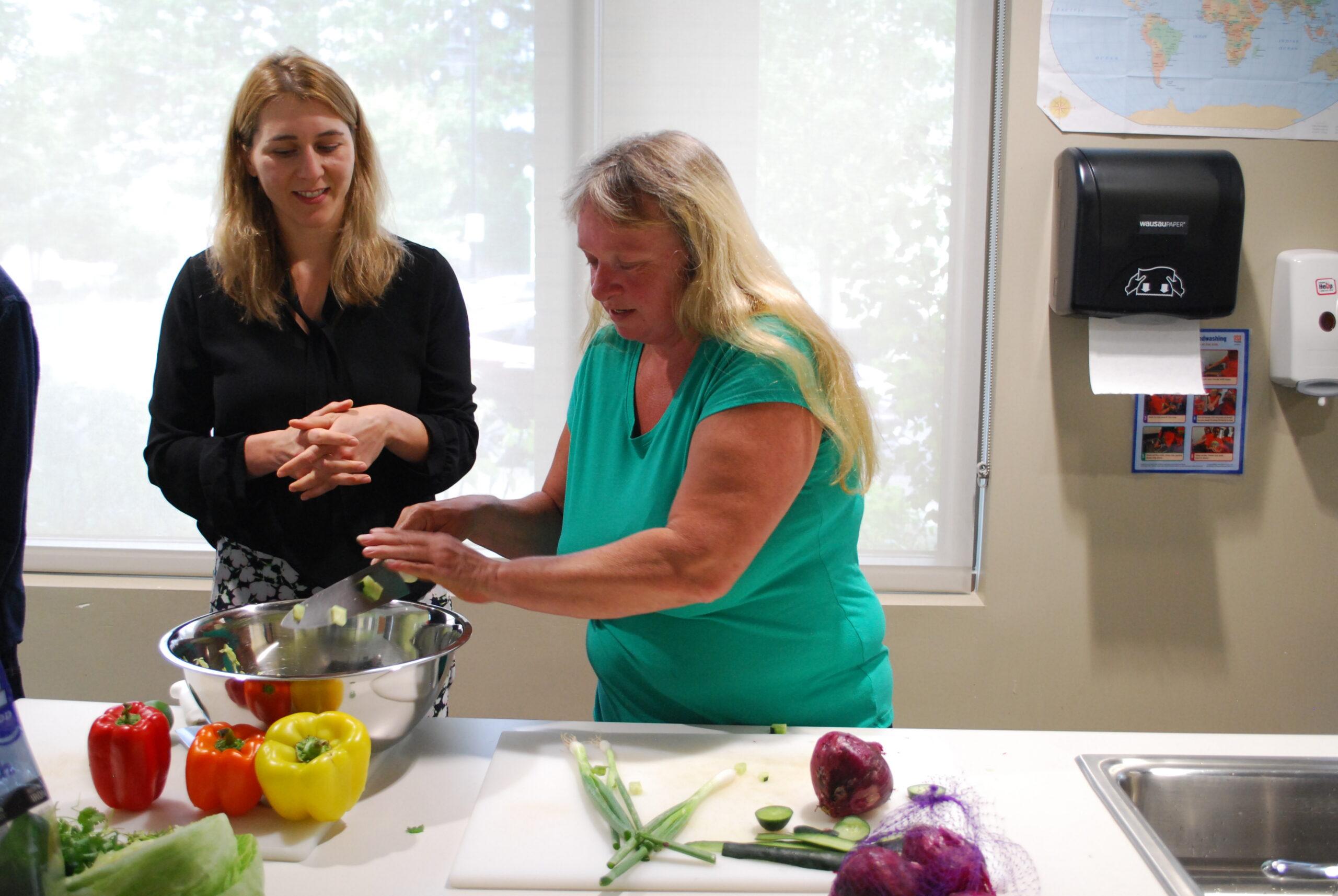 woman chopping vegetables at a counter