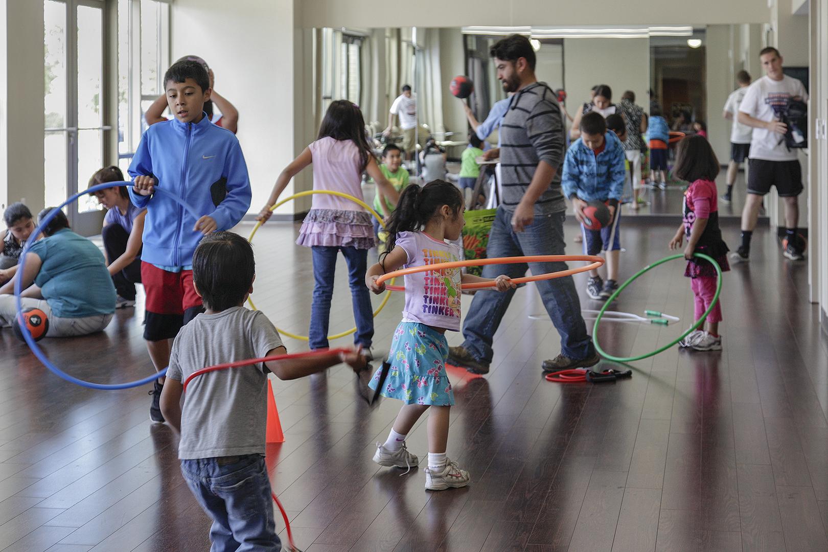 group of children playing with hoolahoops