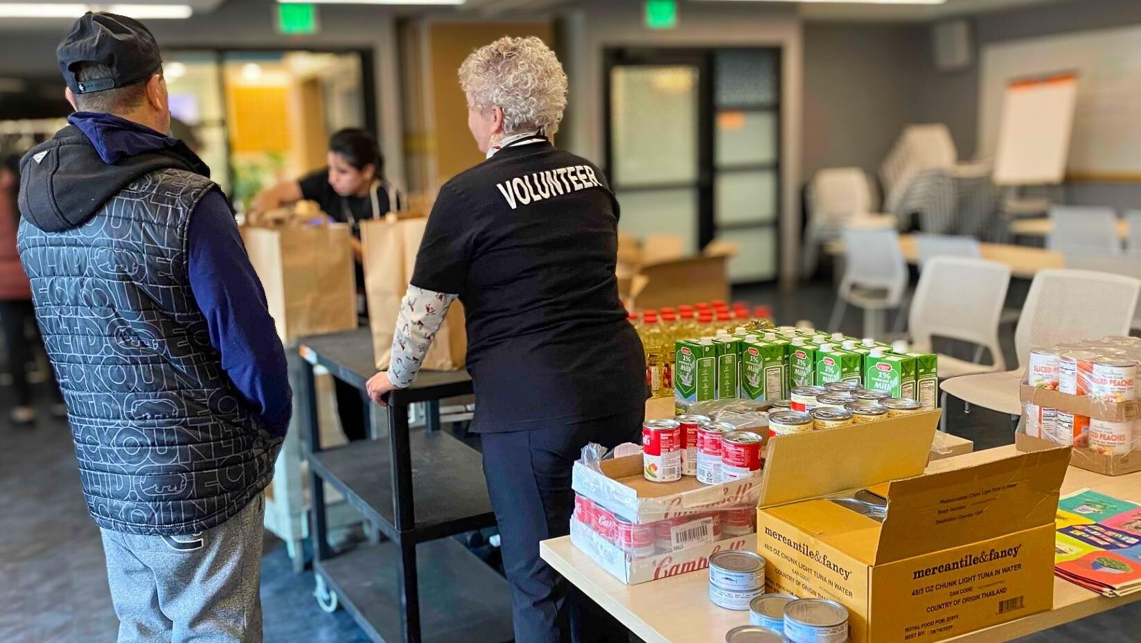 volunteer helping with food donations