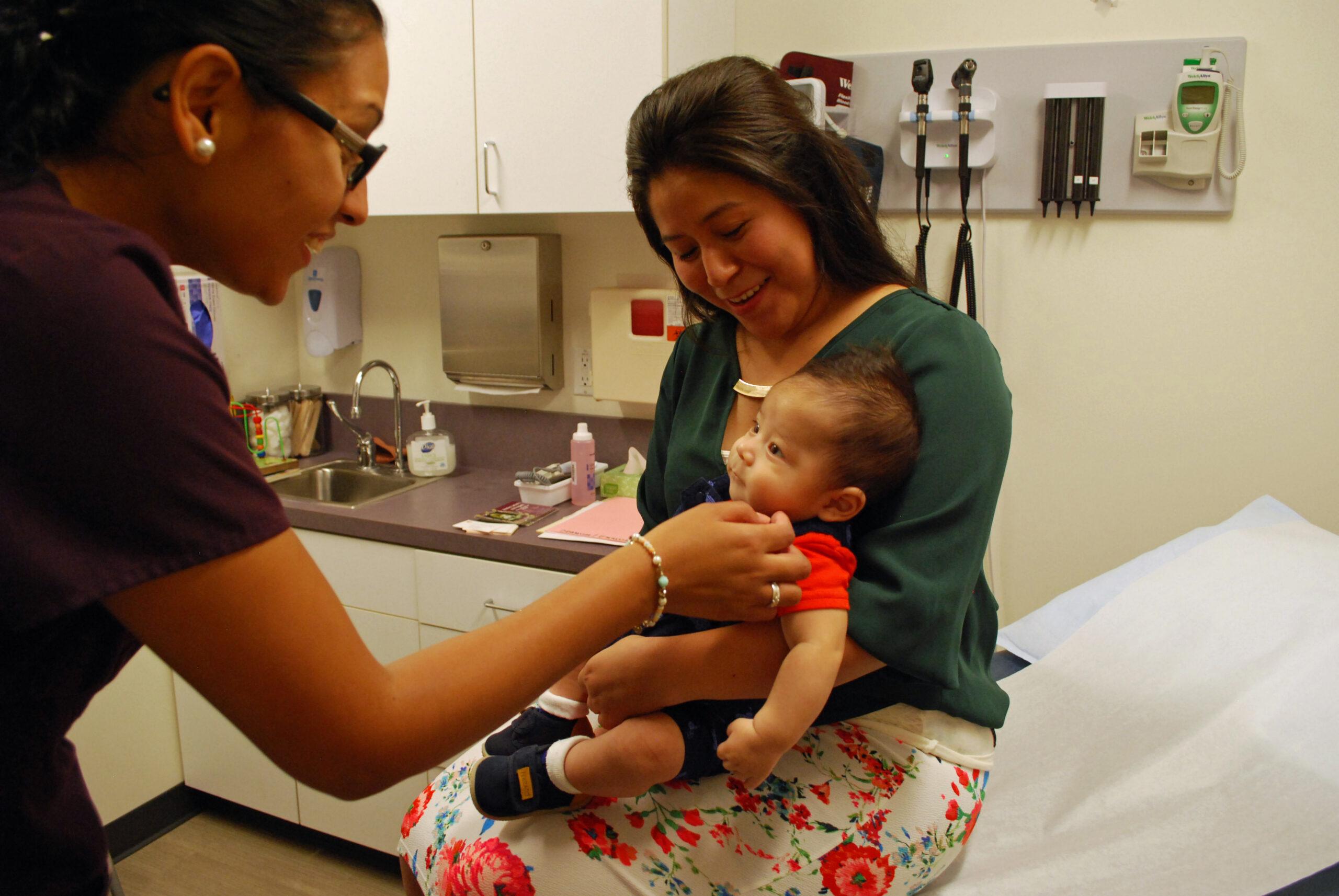 Medical professional performing an exam on an infant