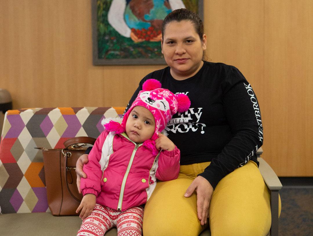 Mother and child sitting in waiting room together