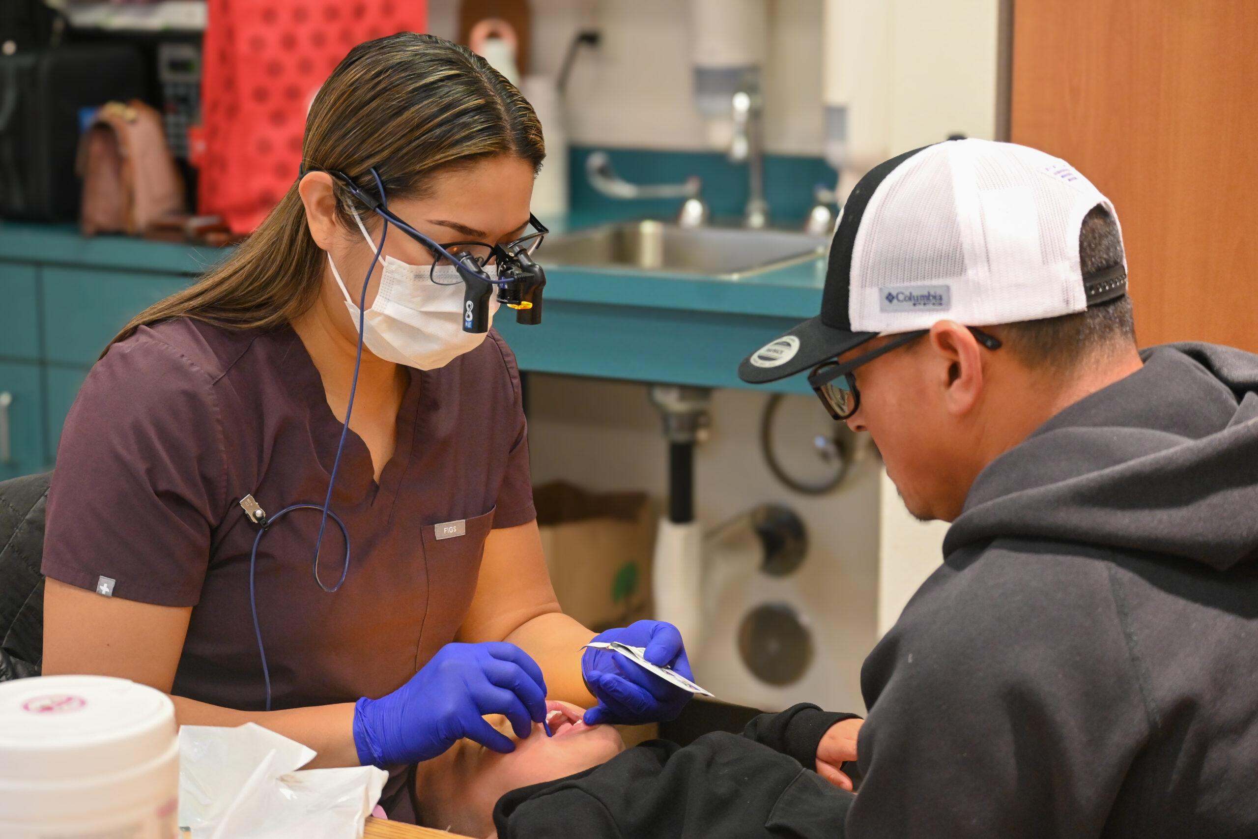 Medical professional working on a child's teeth