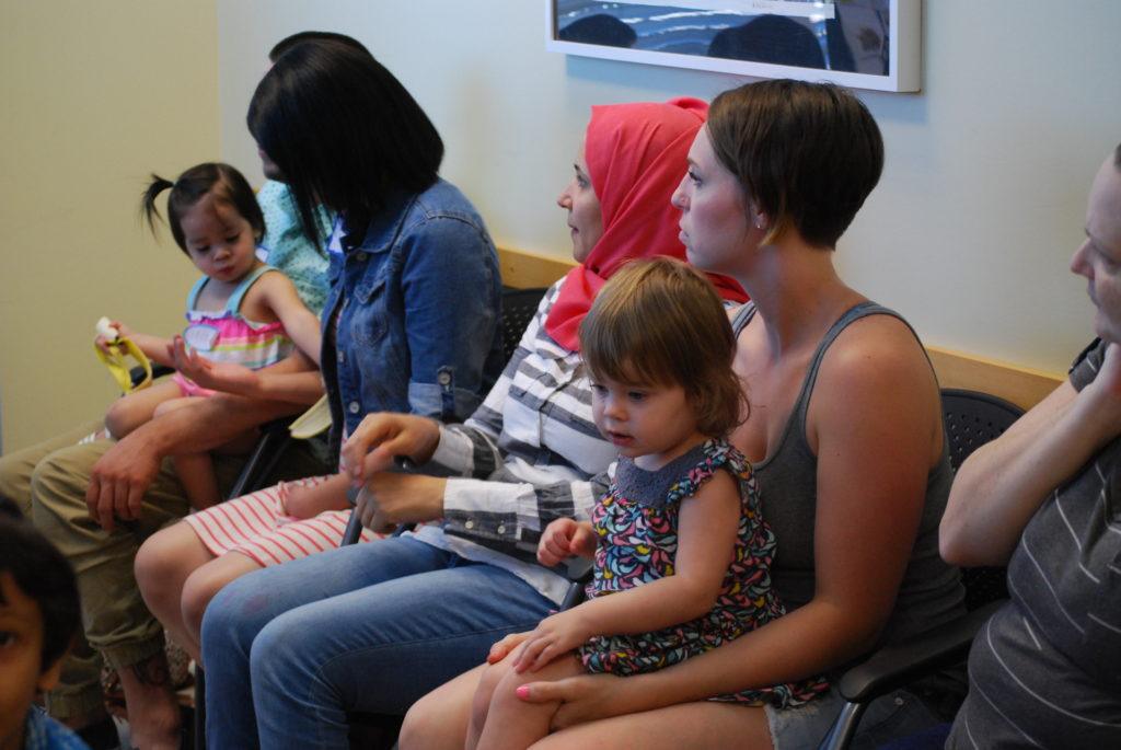 two families sitting on a bench
